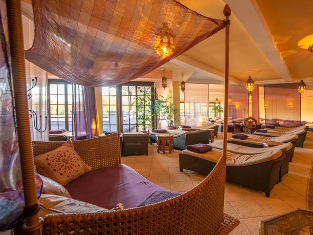 Mediterranean An inviting spa relaxation room with woven loungers, soft lighting and floor-to-ceiling windows.