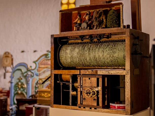 Detailed view of an antique organ cylinder in a historical music automaton museum.