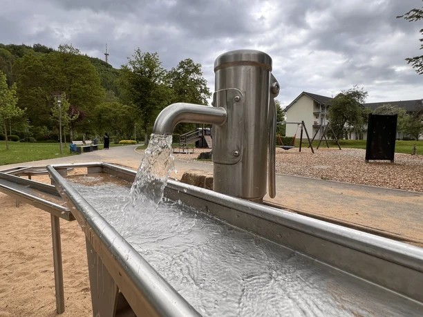 Water playground in the spa park Water playground with stainless steel pumps and narrow water channels in a green park.
