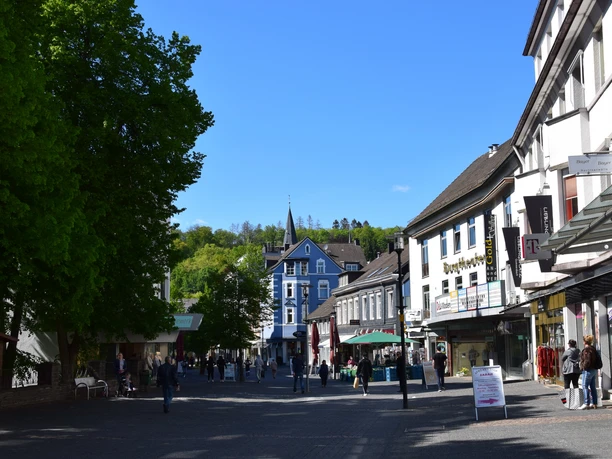 Downtown Gummersbach old town with pedestrian zone, historic buildings and people in sunny weather.
