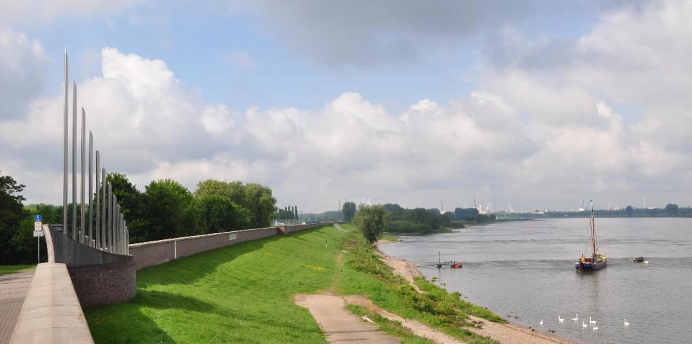 Dyke Monheim am Rhein Green dike section along the Rhine in Monheim, lined with paths and anchored boats.